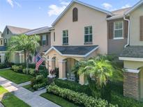 Charming two-story home with front yard featuring lush landscaping and an inviting porch at 14135 Stowbridge Ave, Tampa, FL 33626