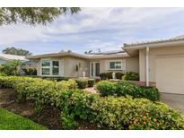 Charming home exterior with a well-manicured front yard and lush landscaping at 1441 S Hercules Ave, Clearwater, FL 33764