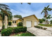 Charming single-Gathering home with a two-car garage and tropical landscaping at 1902 Elaine Dr, Clearwater, FL 33760
