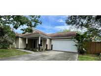 Charming single-story home with a well-maintained lawn, a two car garage and inviting front porch at 2068 Diane Ave, Palm Harbor, FL 34683