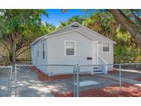 Charming single-story home with a neutral color scheme and a well-maintained yard behind a chainlink fence at 2926 Fairfield S Ave, St Petersburg, FL 33712