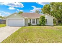 Charming single-story home with a well-manicured lawn and attached two-car garage at 3485 Dothan Ave, Spring Hill, FL 34609