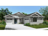 Charming single-story home featuring a symmetrical façade, two-car garage and inviting blue front door at 4590 Southern Valley Loop, Brooksville, FL 34601