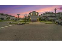 Charming two-story home with attached two-car garage and manicured front lawn at 4608 Emprise Way, Land O Lakes, FL 34638