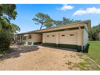 Charming single-story home with a two-car garage and gravel driveway at 5391 54Th N St, St Petersburg, FL 33709