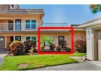 A condominium building featuring well-kept landscaping and a welcoming entrance at 6400 46Th N Ave # 121, Kenneth City, FL 33709