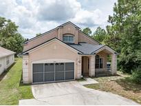 Charming two-story home featuring a spacious two-car garage and inviting front porch at 8050 Diablo Ct, Trinity, FL 34655