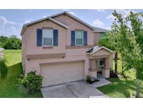 Charming two-story home with a two-car garage and inviting front porch at 8515 Hunters Fork Loop, Ruskin, FL 33573