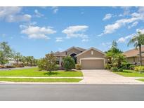 Beautiful single-story home with a well-manicured lawn and lush landscaping in a suburban neighborhood at 9067 39Th Street E Cir, Parrish, FL 34219