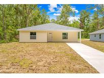 Charming single story home boasts a tidy yard and convenient driveway for easy access at 19267 Wildwood Dr, Brooksville, FL 34601