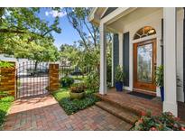 Charming home entrance with brick walkway, beautiful front door and well-manicured landscaping at 2404 W Jetton Ave, Tampa, FL 33629