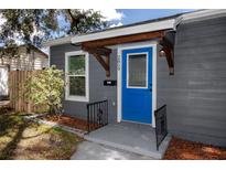 Charming home featuring a vibrant blue front door and well-maintained landscaping at 2859 38Th N Ave, St Petersburg, FL 33713