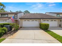 Charming townhome with a well-manicured front yard and an attached one-car garage at 4213 Arborwood Ln, Tampa, FL 33618