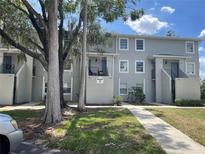 Building 7 exterior featuring well-maintained landscaping and a sidewalk leading to the units at 7192 E Bank Dr, Tampa, FL 33617