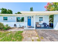 Charming, single-story home with blue exterior, covered entry, and walkway leading to the front door at 10436 117Th Dr, Largo, FL 33773