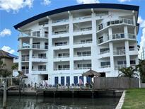 Stunning multi-story waterfront condo with a private dock, tiki huts, and stunning architectural details at 100 Bayside Dr # 202, Clearwater Beach, FL 33767