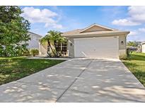 Charming single-story home featuring a well-maintained lawn, mature landscaping, and a two-car garage at 11835 Shrewsbury Ln, Parrish, FL 34219