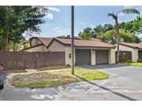 Charming townhouse with a two-car garage, a fenced yard, and a well-maintained exterior at 2095 Sunset Point Rd # 2201, Clearwater, FL 33765