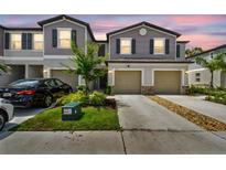Charming townhome showcasing well-manicured lawn and a two-car garage, enhancing its curb appeal at 2513 Sunray Venus Way, Ruskin, FL 33570