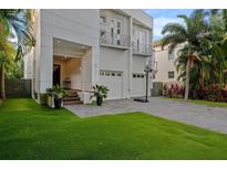 Modern home with a manicured lawn, two-car garage and balcony at 2711 W Trilby Ave, Tampa, FL 33611
