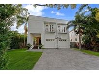 Stunning modern home with a well-manicured lawn, two-car garage and second story balconies at 2711 W Trilby Ave, Tampa, FL 33611