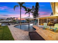 Beautiful waterfront pool and patio area perfect for entertaining guests and watching the sunset at 4252 Floramar Ter, New Port Richey, FL 34652