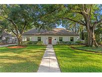 Charming single-story home with lush lawn and mature trees at 4708 W Neptune St, Tampa, FL 33629