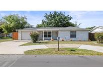 Charming single-story home featuring a well-maintained front yard and a classic brick facade at 7814 Judith Cres, Port Richey, FL 34668