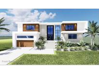 Contemporary two-story home features a modern design with a two-car garage, beautiful front yard, and eye-catching curb appeal at 7849 Marsh Pointe Dr, Tampa, FL 33635