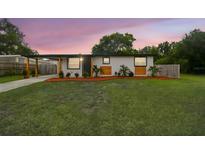 Charming single-story home with a well-manicured lawn and lovely landscaping at 8108 Fir Dr, Tampa, FL 33619