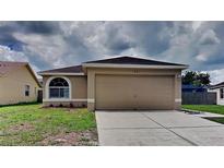 Charming single-story home with a well-maintained lawn and attached two-car garage at 1421 Mohrlake Dr, Brandon, FL 33511