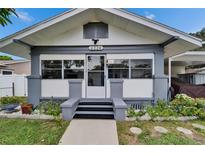 Charming bungalow featuring a symmetrical facade, gray trim, and a well-maintained landscaped yard at 2334 14Th N Ave, St Petersburg, FL 33713