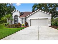 Charming single-story home with a two-car garage, manicured landscaping, and a tile roof at 2772 Golf Lake Dr # 03, Plant City, FL 33566