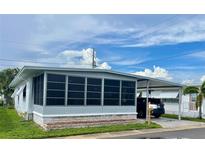 Charming single-story home with a screened-in porch and covered parking area at 34645 Camphor N Dr, Pinellas Park, FL 33781