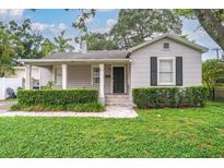 Charming single-story home with a well-manicured lawn and classic architectural details at 3503 W Palmira Ave, Tampa, FL 33629