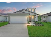 Charming single Gathering home featuring a well-manicured lawn, two-car garage, and inviting entrance at 3655 Moscato Dr, Brooksville, FL 34602