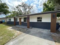 Single-story home features fresh exterior paint, new brick, new porch columns and a concrete driveway at 4415 Tuna Dr, Tampa, FL 33617