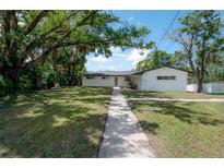 Charming one-story home featuring a well-manicured lawn and inviting walkway at 6108 Oak Ridge Ave, New Port Richey, FL 34653
