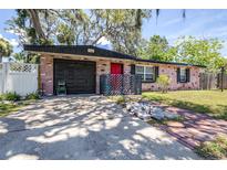Cozy one story brick home with attached garage, mature trees, and unique decor at 7441 Cypress Dr, New Port Richey, FL 34653