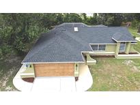 Aerial view of a well-maintained, single-story home with a modern roof and a two-car garage at 10287 Fordham St, Spring Hill, FL 34608