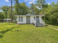 Charming single-story home with stone accents, gray front door, and a well-maintained lawn at 111 E Early St, Brooksville, FL 34601