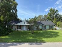 Charming single-story home with a well-maintained lawn and mature trees, offering great curb appeal at 2005 Capri Rd, Valrico, FL 33594