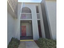 Exterior view of building entrance featuring covered walkway and upper floor balcony at 3123 29Th N Ave # 105, St Petersburg, FL 33713