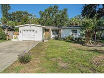 Charming single-story home with a well-manicured lawn and attached one car garage at 4210 Huntington Ne St, St Petersburg, FL 33703