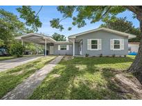 Charming single-story home featuring a carport, well-maintained lawn, and quaint curb appeal at 4570 Essex Ln, Spring Hill, FL 34606