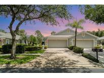 Charming home with a three-car garage, mature landscaping, and well-maintained lawn at 5814 Heronpark Pl, Lithia, FL 33547