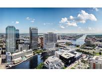 Stunning aerial view of a modern building in Tampa, Florida near the water with bright blue skies at 111 S Ashley Dr # 3308, Tampa, FL 33602