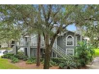 Charming exterior view of a multi-story home with mature trees and landscaping at 11941 Skylake Pl # 11941, Temple Terrace, FL 33617