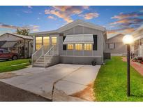 Charming single-Gathering home featuring a well-manicured lawn and spacious driveway at dusk with great curb appeal at 3333 26Th E Ave # 1090, Bradenton, FL 34208