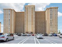 Spacious condo building exterior with parking lot and a neutral color palette on a sunny day at 5200 Brittany S Dr # 1501, St Petersburg, FL 33715